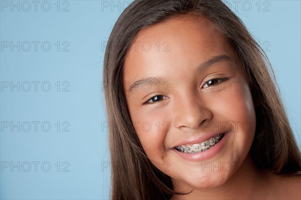 Studio portrait of girl smiling (10-11). Photo : Rob Lewine