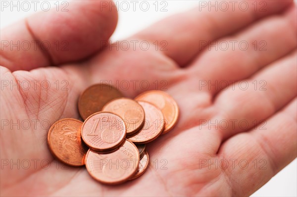 Hand with one cents coins.