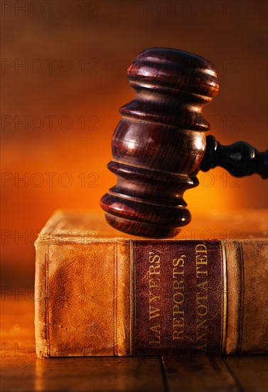 Close-up of gavel on lawyer book.