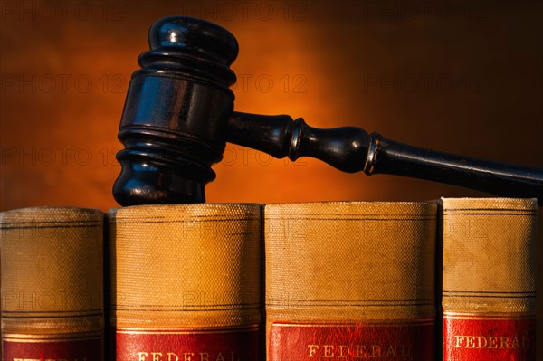 Close-up of gavel on lawyer books.