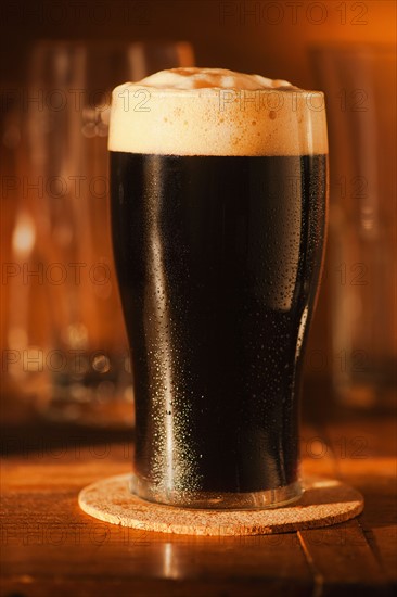 Ale in beer glass on bar counter.