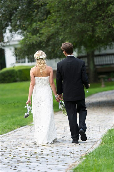Newly wed couple walking together.