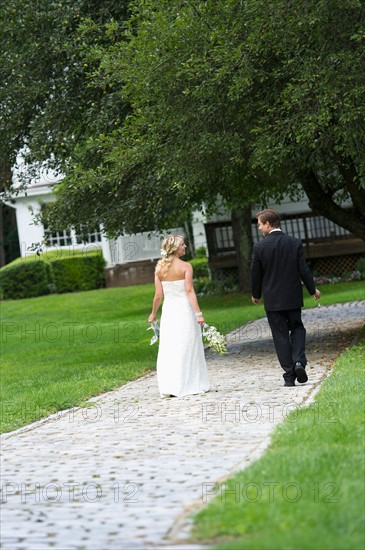 Newly wed couple walking together.