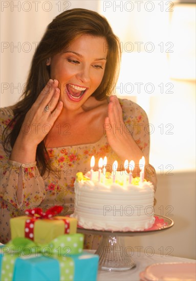 Woman looking at birthday cake.