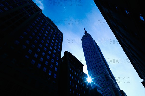 USA, New York City, Empire State Building with solar flare.