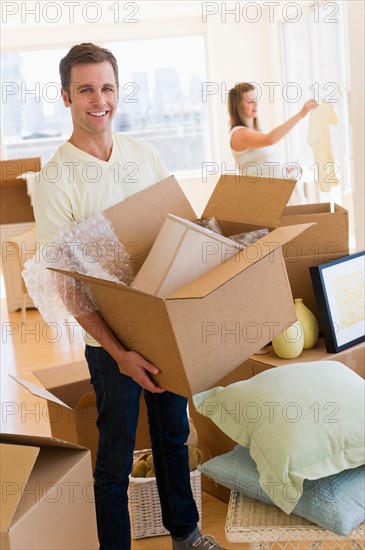 Young couple unpacking.