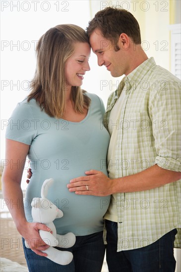 Young couple standing in nursery.