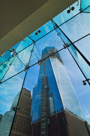 USA, New York, New York City, Lower Manhattan, Ground Zero, reflection of Freedom Tower in glass wall.