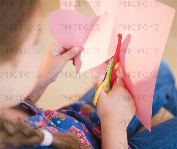 Girl ( 6-7) cutting heart shape for valentine's day. Photo : Jamie Grill
