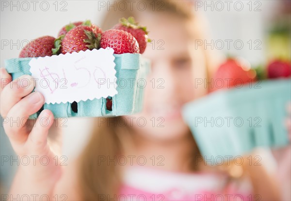 Girl ( 6-7) selling fresh strawberries. Photo : Jamie Grill