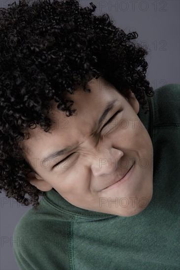 Portrait of boy (8-9) looking angry, studio shot. Photo : Rob Lewine