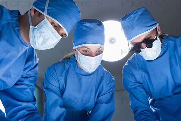 Three surgeons operating.