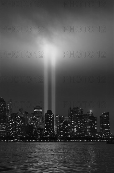 USA, New York City, Manhattan skyline with 9/11 memorial lights.