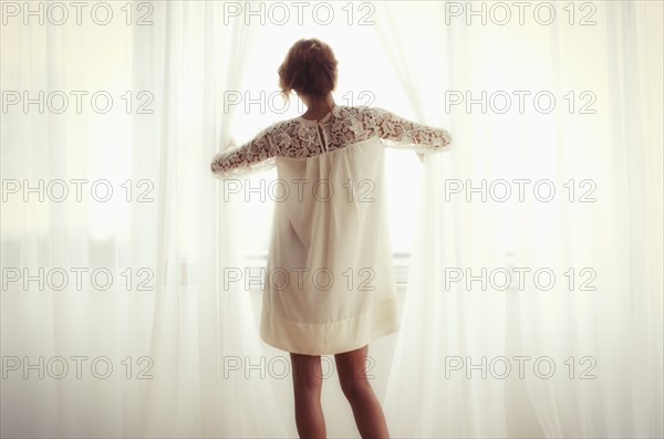 Woman looking out window.