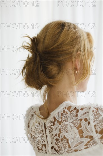 Woman looking out window.