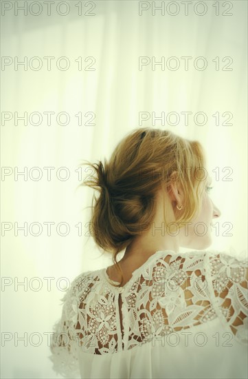 Woman looking out window.