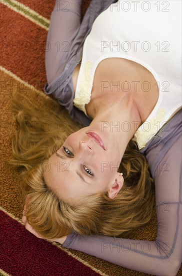 Portrait of woman lying on floor.