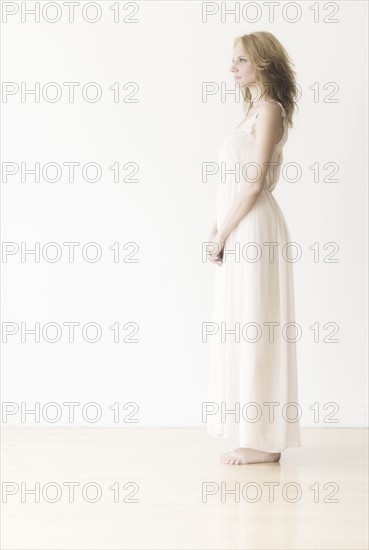 Woman against white background, studio shot.