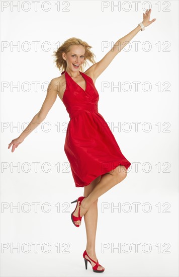 Studio portrait of woman in red dress.