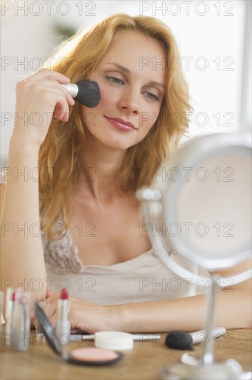 Woman applying make-up.