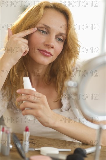 Woman applying make-up.