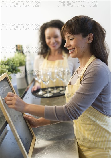 Two female business owners in restaurant.