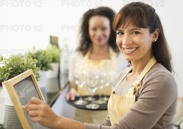 Two female business owners in restaurant.