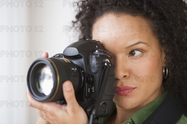 Woman taking pictures with digital camera.