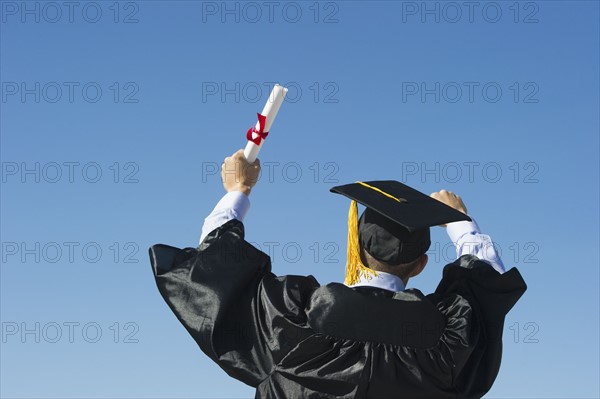 Teenage boy (16-17) at his graduation ceremony.