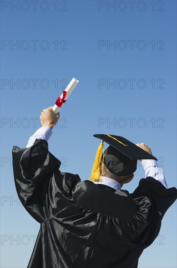 Teenage boy (16-17) at his graduation ceremony.