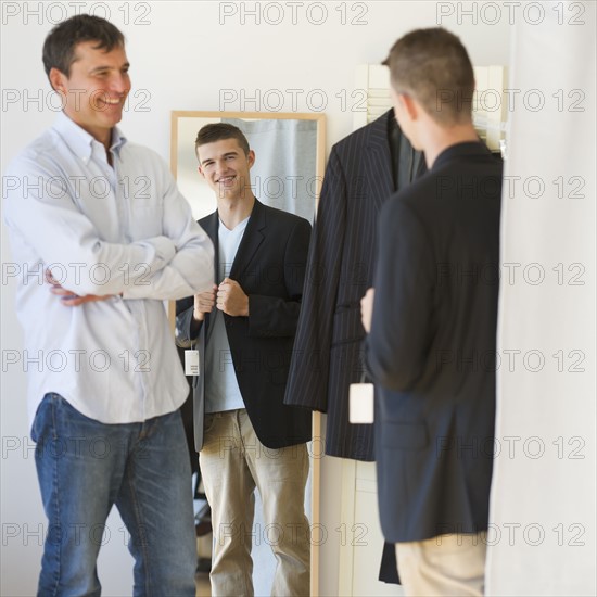 Father with teenage (16-17) son buying suit.