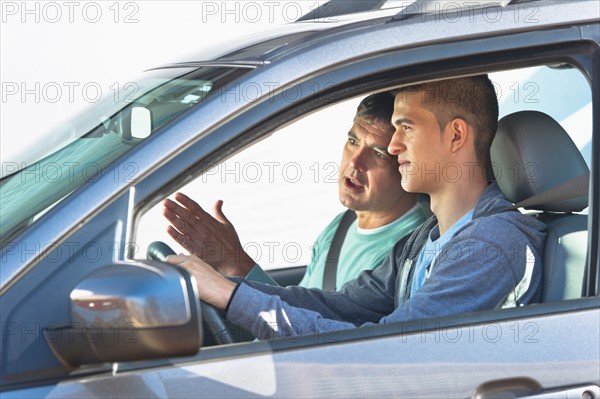 Father with teenage (16-17) son driving.