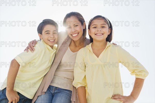 Portrait of mother with son (12-13) and daughter (10-11).