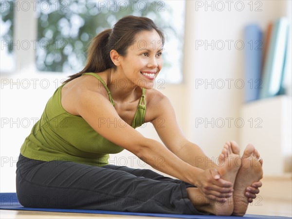 Mid adult woman training with dumbbell.