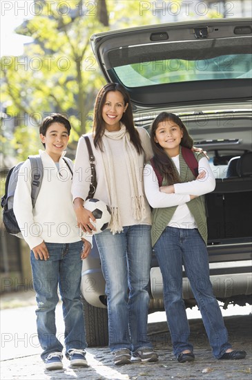 Portrait of mother with son (12-13) and daughter (10-11) .