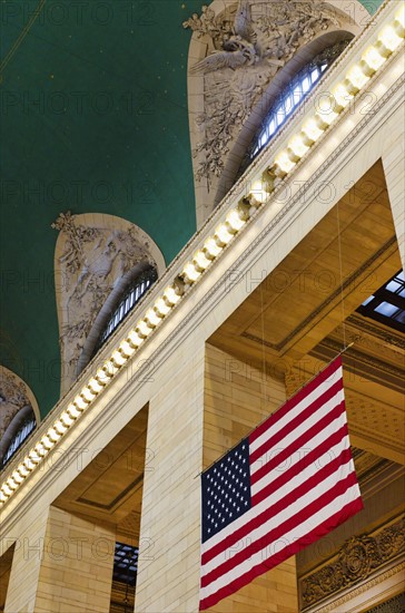 USA, New York State, New York City, Interior of Grand Central Station with American flag.