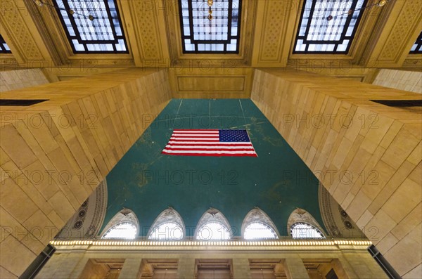 USA, New York State, New York City, Interior of Grand Central Station with American flag.