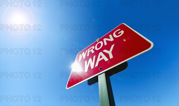 Low angle view of "wrong way" sign.