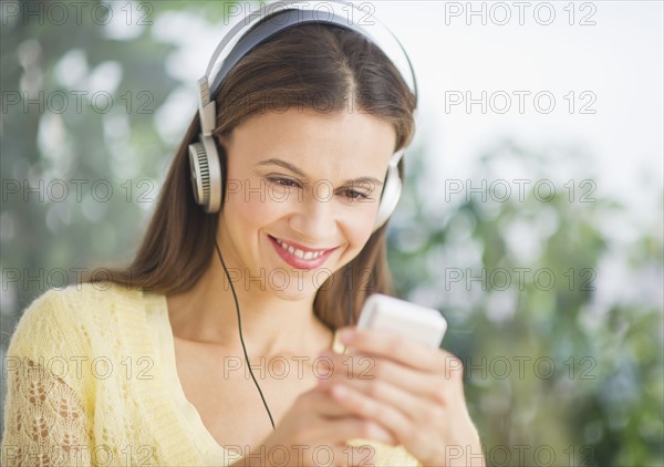 Woman with headphones outdoors.