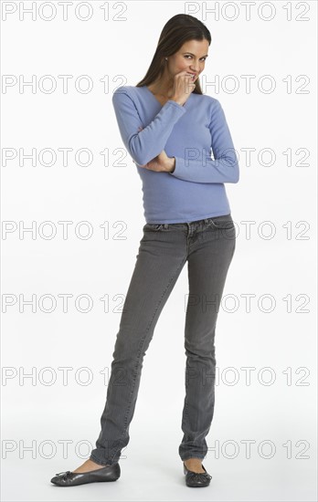 Studio shot of woman biting finger.