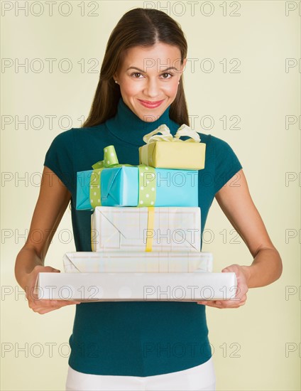 Studio shot of woman holding presents.
