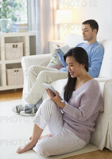 Couple relaxing in living room.