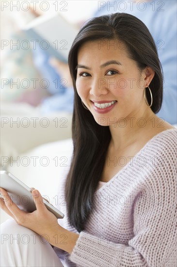 Woman using digital tablet at home.