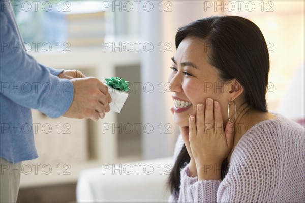Man giving to woman engagement ring.