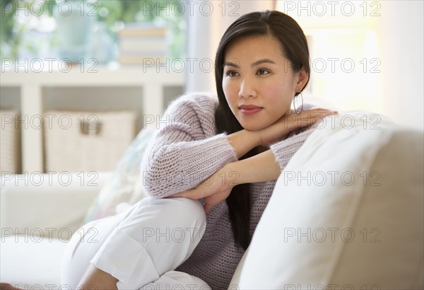 Woman relaxing on sofa.