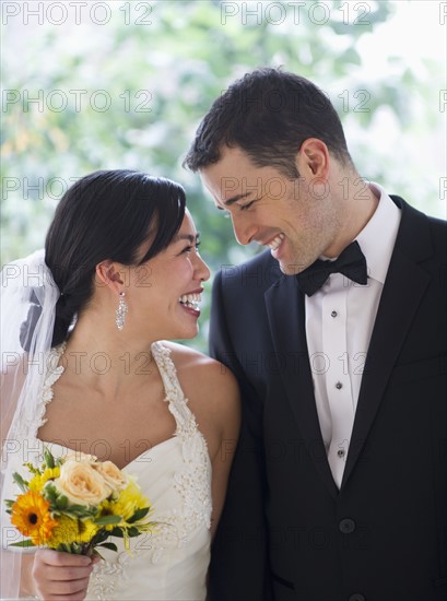 Bride and groom looking at each other.