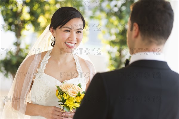 Bride and groom looking at each other.