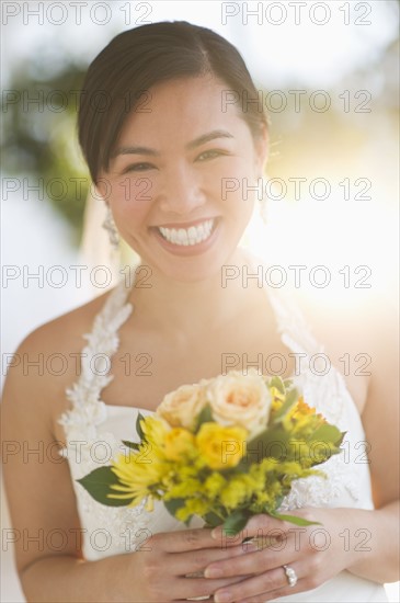 Portrait of bride holding bouquet.