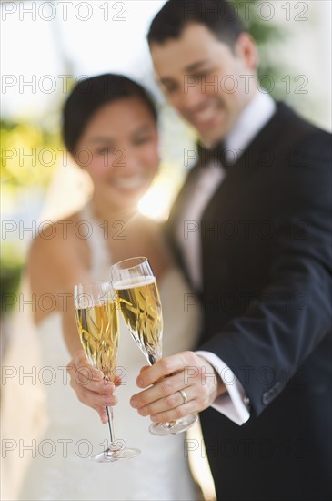 Bride and groom toasting with champagne.