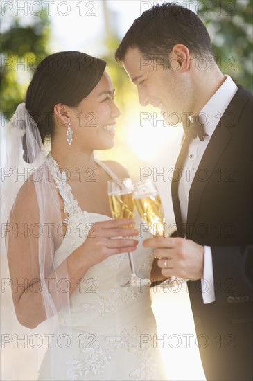 Bride and groom toasting with champagne.